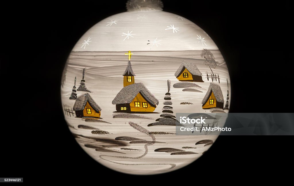 White Winter Landscape Closeup of a white Christmas bauble on black, depicting a winter village landscape Advent Stock Photo