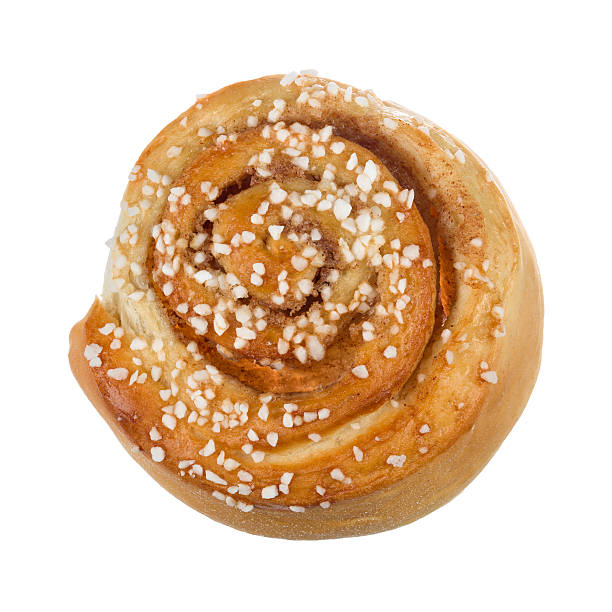 close up of a cinnamon roll. close up of a single cinnamon roll on white baclground. sweet bun stock pictures, royalty-free photos & images