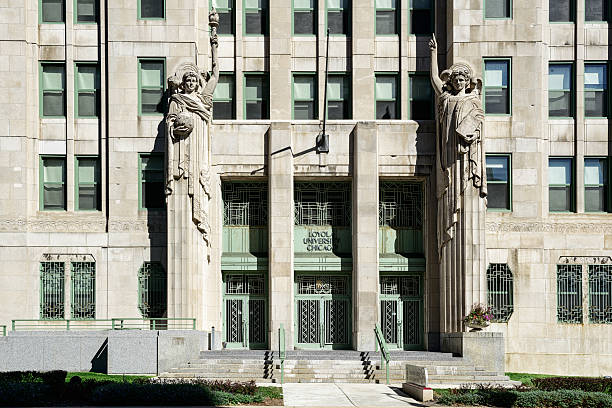 Mundelein College Entrance, Loyola University,  Chicago Chicago, USA - September 14, 2013: Entrance to Mundelein College  (Mundelein Center), Loyola University  in Rogers Park, a Chicago community on the Far North Side.  Guardian angels architectural detail.  Art deco building (built 1930). No people. ncaa college conference team stock pictures, royalty-free photos & images