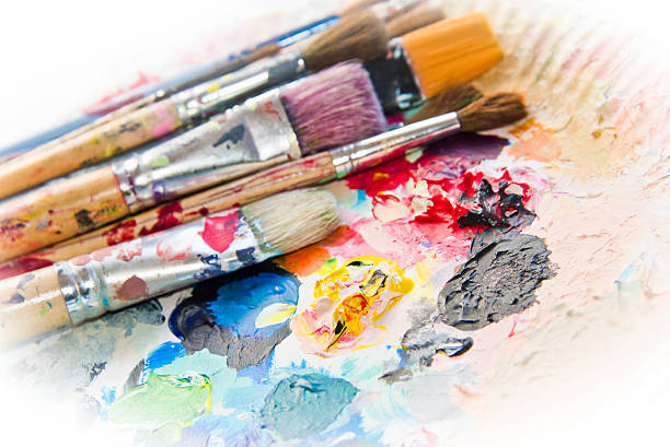 istock Used paint brushes on a colorful painter palette 523455719