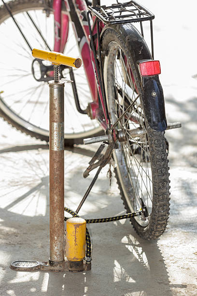 istock Old air pump and bicycle tire. 523459101