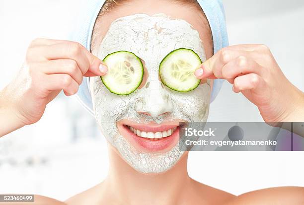 Funny Young Girl With Mask For Skin Face And Cucumbers Stock Photo - Download Image Now