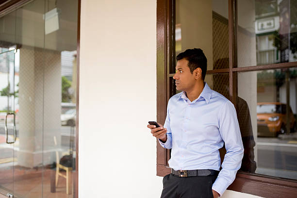 istock Indian businessman using mobile phone 523461361