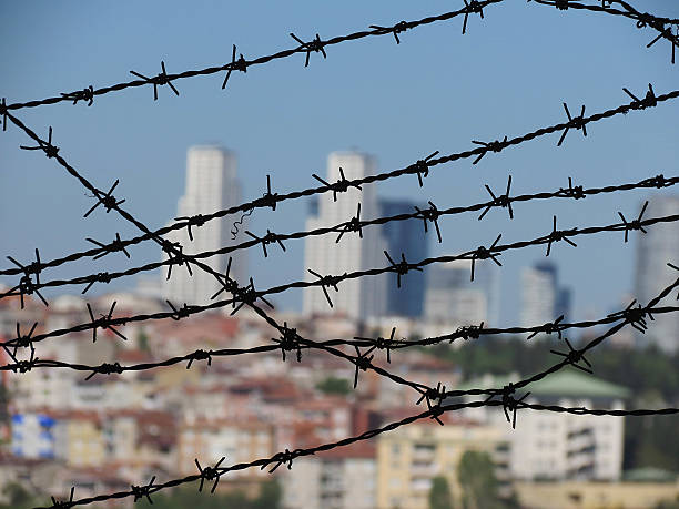 Barbed wire and city landscapeBarbed wire and city landscape