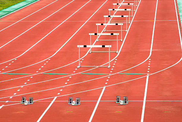 The starting blocks and the hurdles The starting blocks and the hurdles. track and field stadium stock pictures, royalty-free photos & images