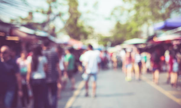 Blurred background : people shopping at market fair stock photo