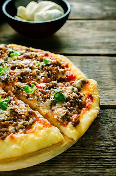 istock pizza with meat, mozzarella and oregano 523472155