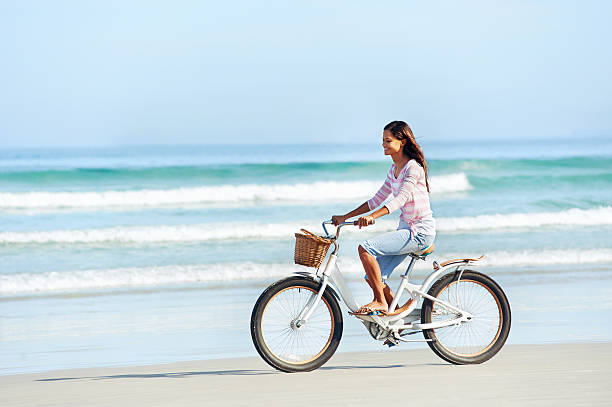 istock beach bicycle woman 523476895