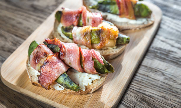 istock Toasts with cream cheese and avocado wrapped in bacon 523477282