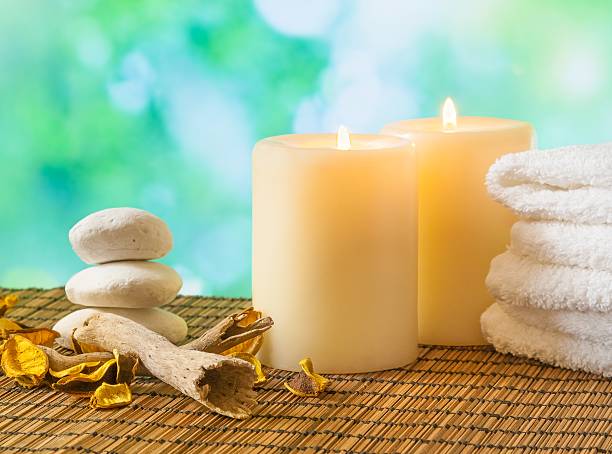 istock spa massage border background with towel stacked, candles and stone 523477410
