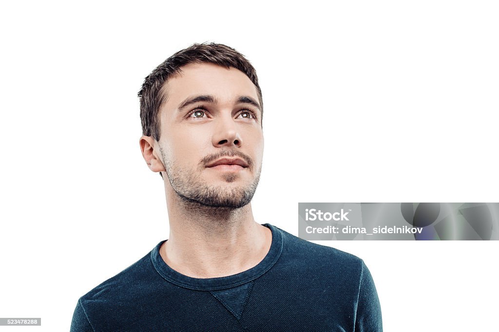 Handsome young man on white background Portrait of stylish handsome young man isolated on white background. Man looking up. Free space for logo Portrait Stock Photo
