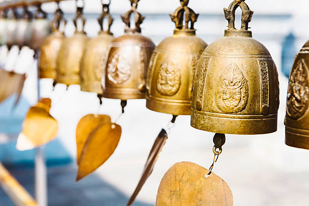 istock Many golden buddhist bells with wishes in sunlight 523479590