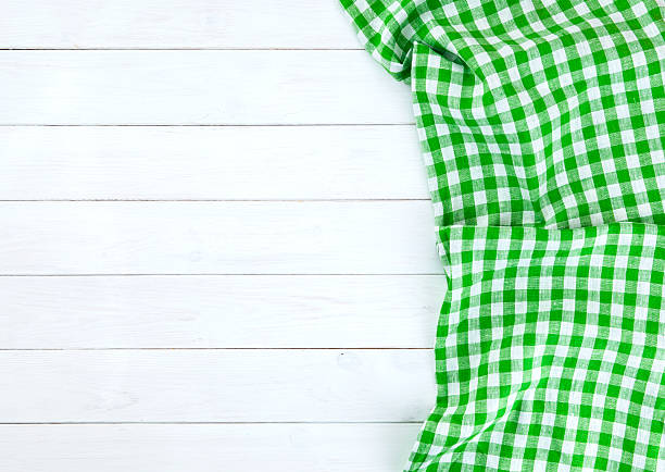 istock Green tablecloth on white wood table 523479704