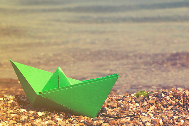 istock Paper boat on the beach 523481768