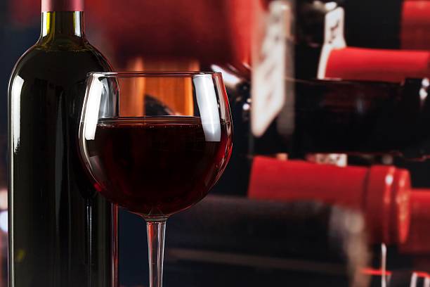 istock wine glass near bottle in wine cellar 523481884
