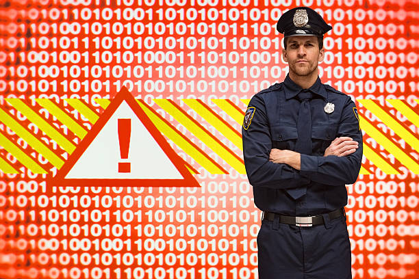istock Smiling police standing with arms crossed 523484670