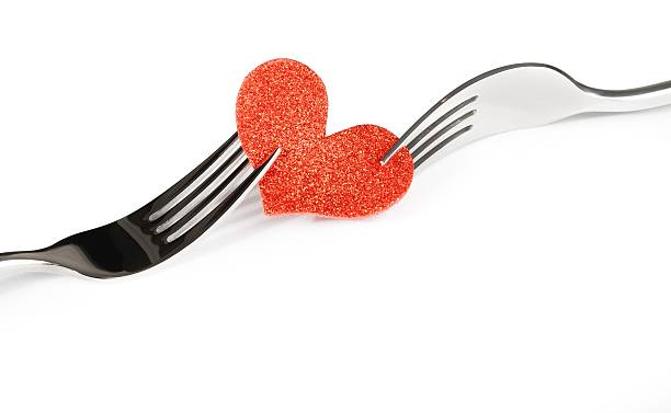 istock decorative red heart near forks on white background 523487512