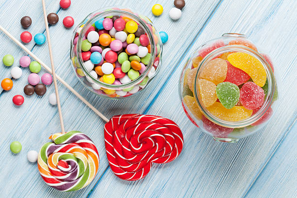 istock Colorful candies on wooden table 523488642