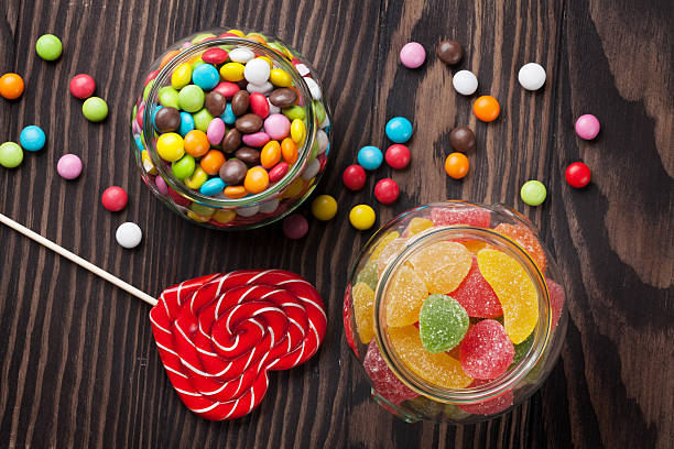 istock Colorful candies on wooden table 523488806