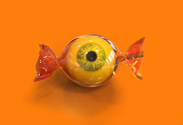 Eye ball halloween candy Eye ball halloween candy on orange background, 3d ugliness photos stock pictures, royalty-free photos & images
