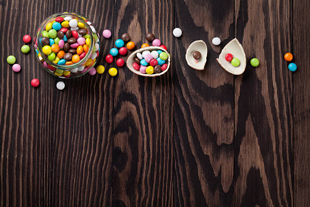 istock Colorful candies on wooden table 523488904