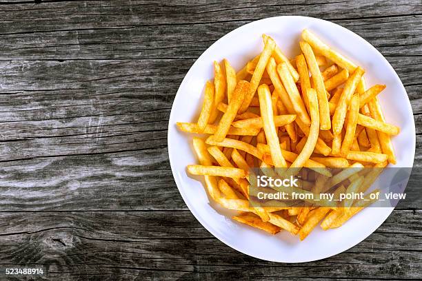 Tasty French Fries On Plate On Wooden Table Background Stock Photo - Download Image Now