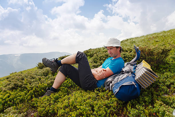 istock Hiker takes rest during hiking in mountains 523489346