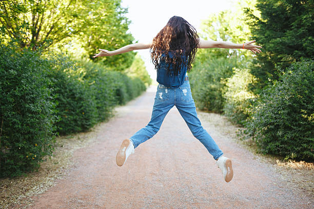 istock Young woman jumping footpath in nature 523490034