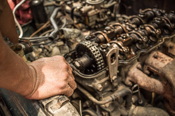 istock mechanic hand on old & grunge car engine inside view 523492706