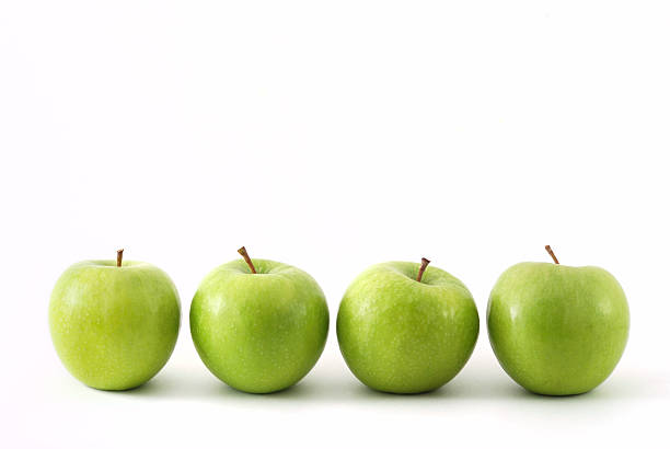 istock Four green apples in a row 523492832