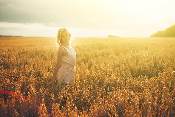istock Beautiful woman walking on wheat field 523494344