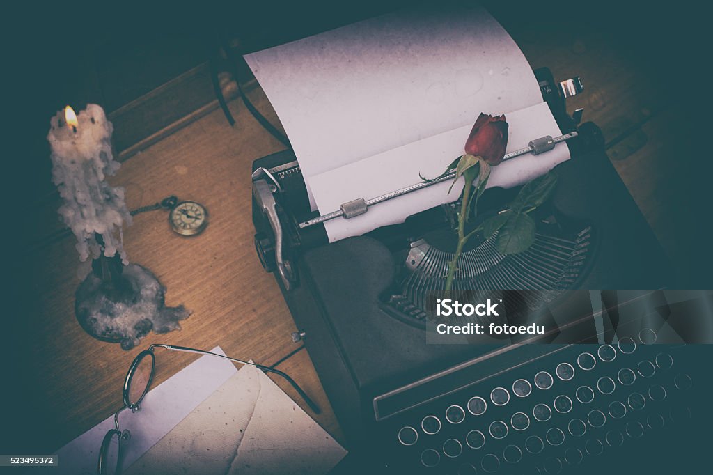 Antique typewriter Antique typewriter on a desk and a candle Machinery Stock Photo