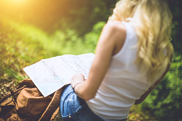istock back view of female holding map 523499190