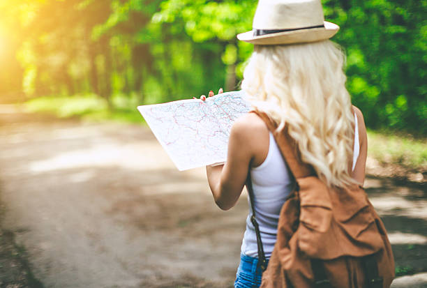 istock back view of young woman holding map 523499690