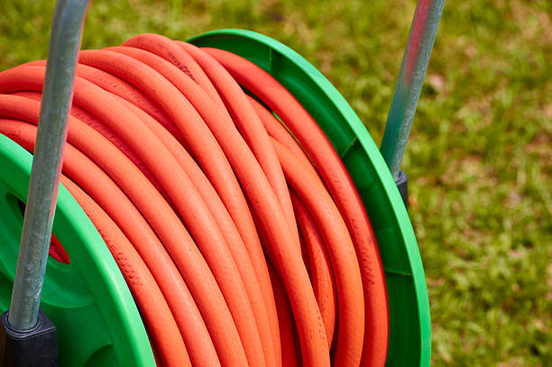 istock coil with orange rubber hose in the garden 523500268