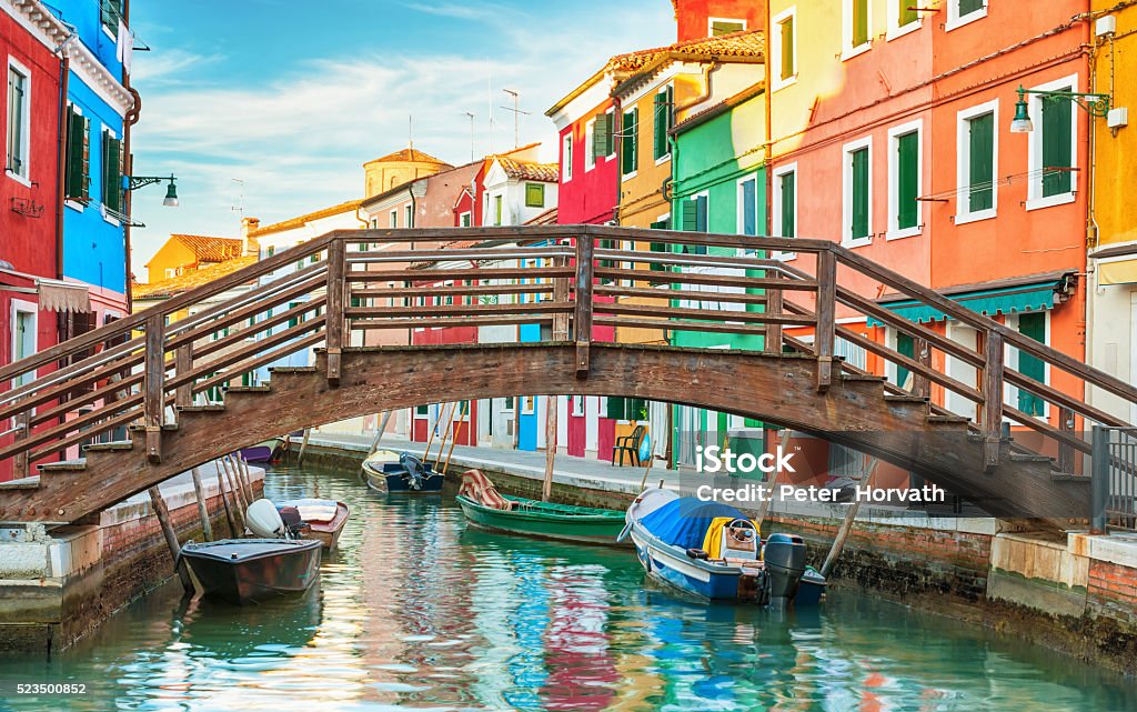 Small wooden bridge over a canal in Burano, Italy. Architecture Stock Photo