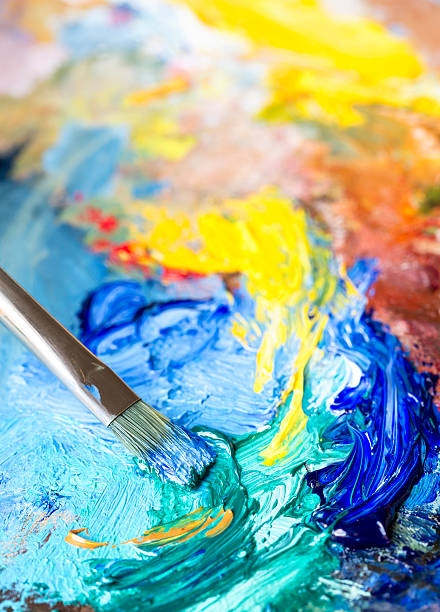 istock Paintbrush with oil paint on a classical palette 523509949