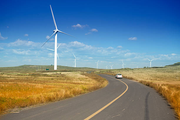 istock Wind farm beside the road against blue sky 523511435