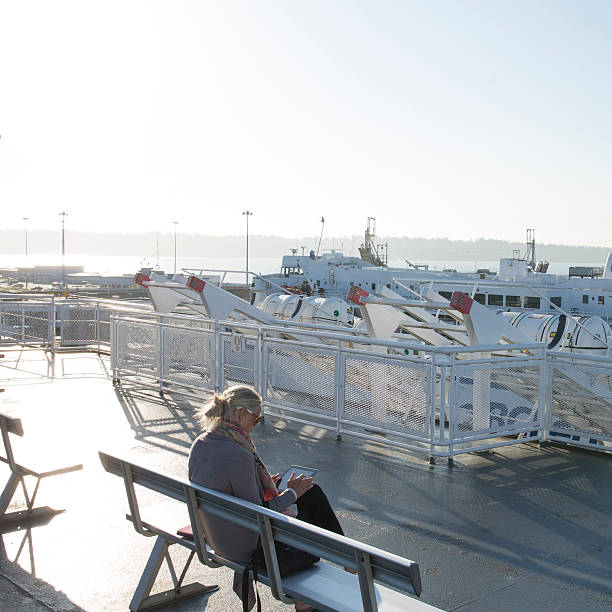 istock Woman uses digital tablet on ferry boat 523512661