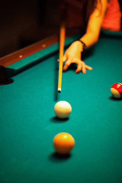 istock Girl pinting with billiard cue 523512745