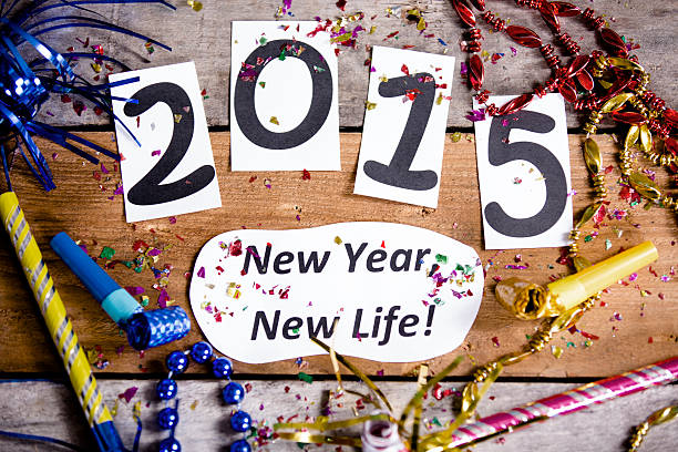 The new year 2015 at top with party decorations all around.  New Year's Resolution reads  \