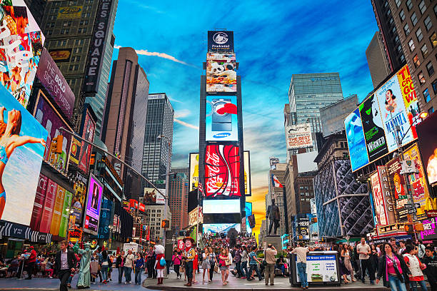 Times square in New York City New York, USA - May 11, 2013: Times Square with tourists. Iconified as "The Crossroads of the World" it's the brightly illuminated hub of the Broadway Theater District. theatre district stock pictures, royalty-free photos & images