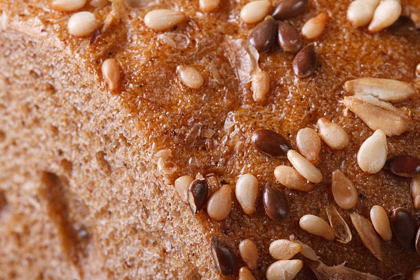 istock Sliced bread with sunflower seeds and nuts closeup 523514211