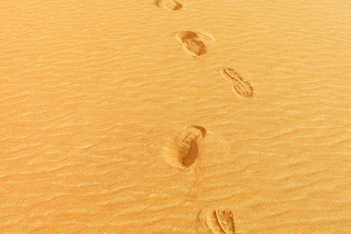 Close-up photo of footprints on the sand of a desert in the United Arab Emirates