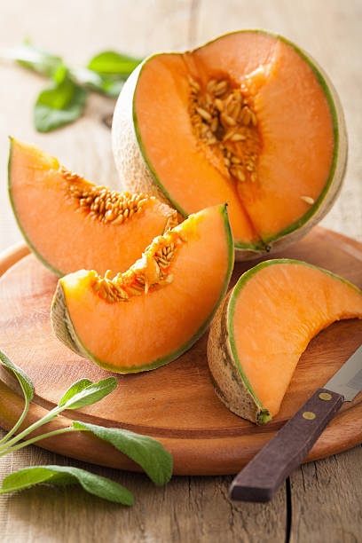 istock cantaloupe melon sliced on wooden background 523515237