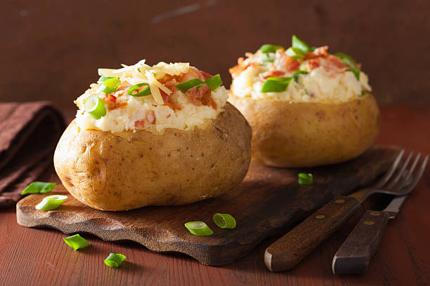 istock baked potato in jacket with bacon and cheese 523516633