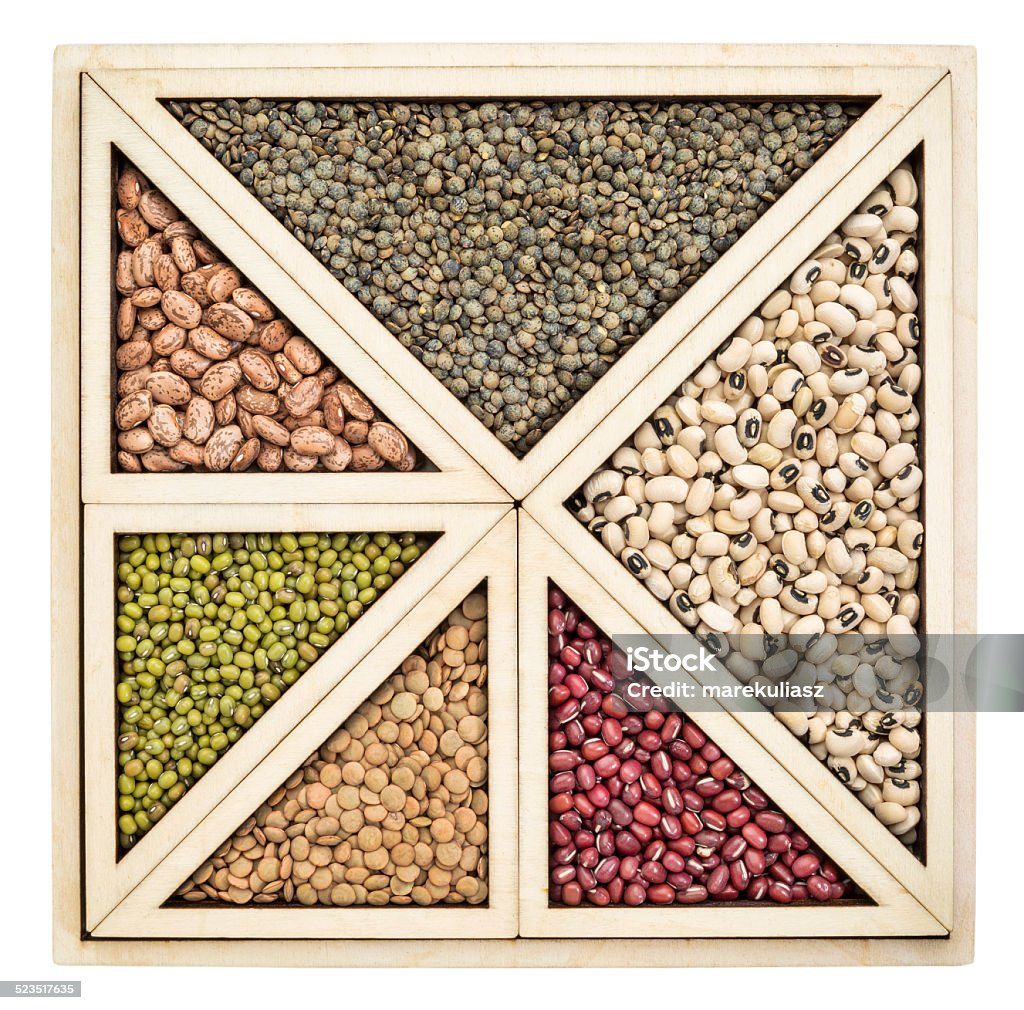 beans and lentils abstract triangles and squares abstract  - a variety of beans and lentils in an isolated wooden tray Abstract Stock Photo