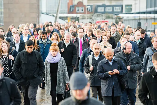 Business people commuting. Large sea of humanity. Commuters on London Bridge.