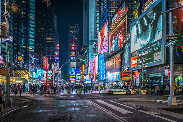 Times Square Time Square in New York city by night new york stock pictures, royalty-free photos & images