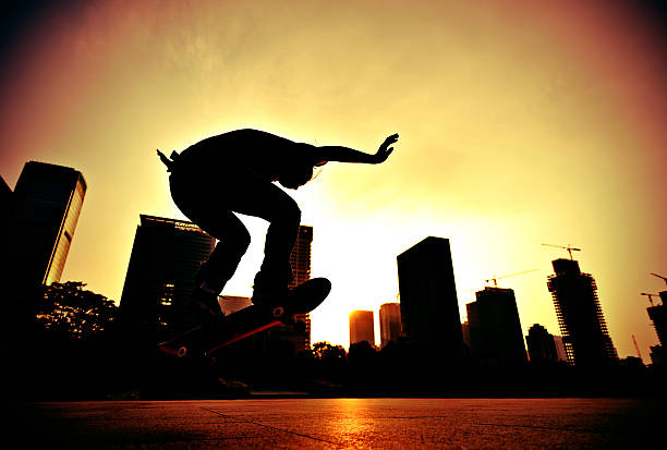 istock skateboarding woman jumping at  sunrise 523539531